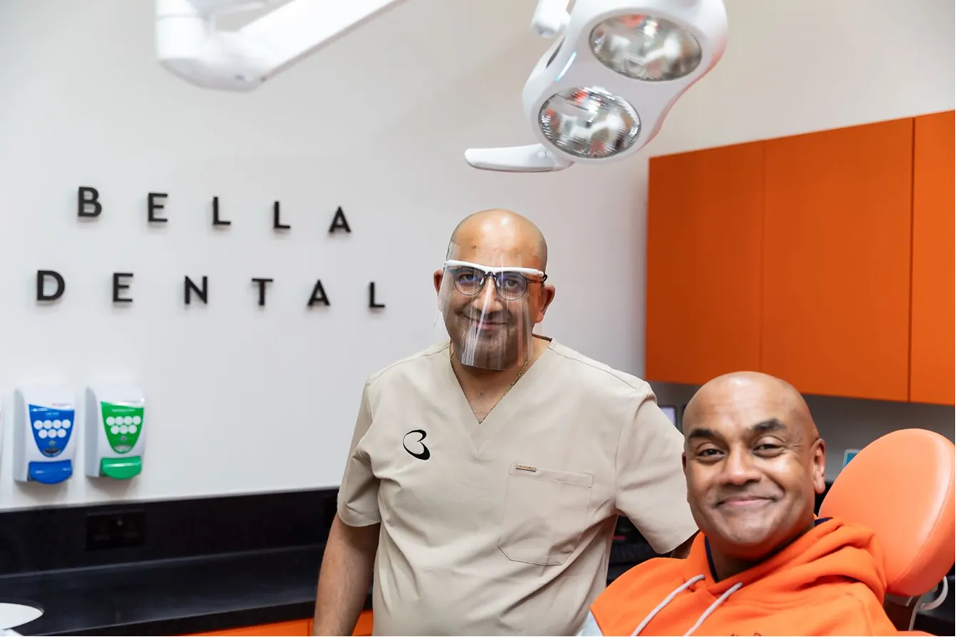 Dr Boulis beside a relaxed, smiling patient in the dental chair