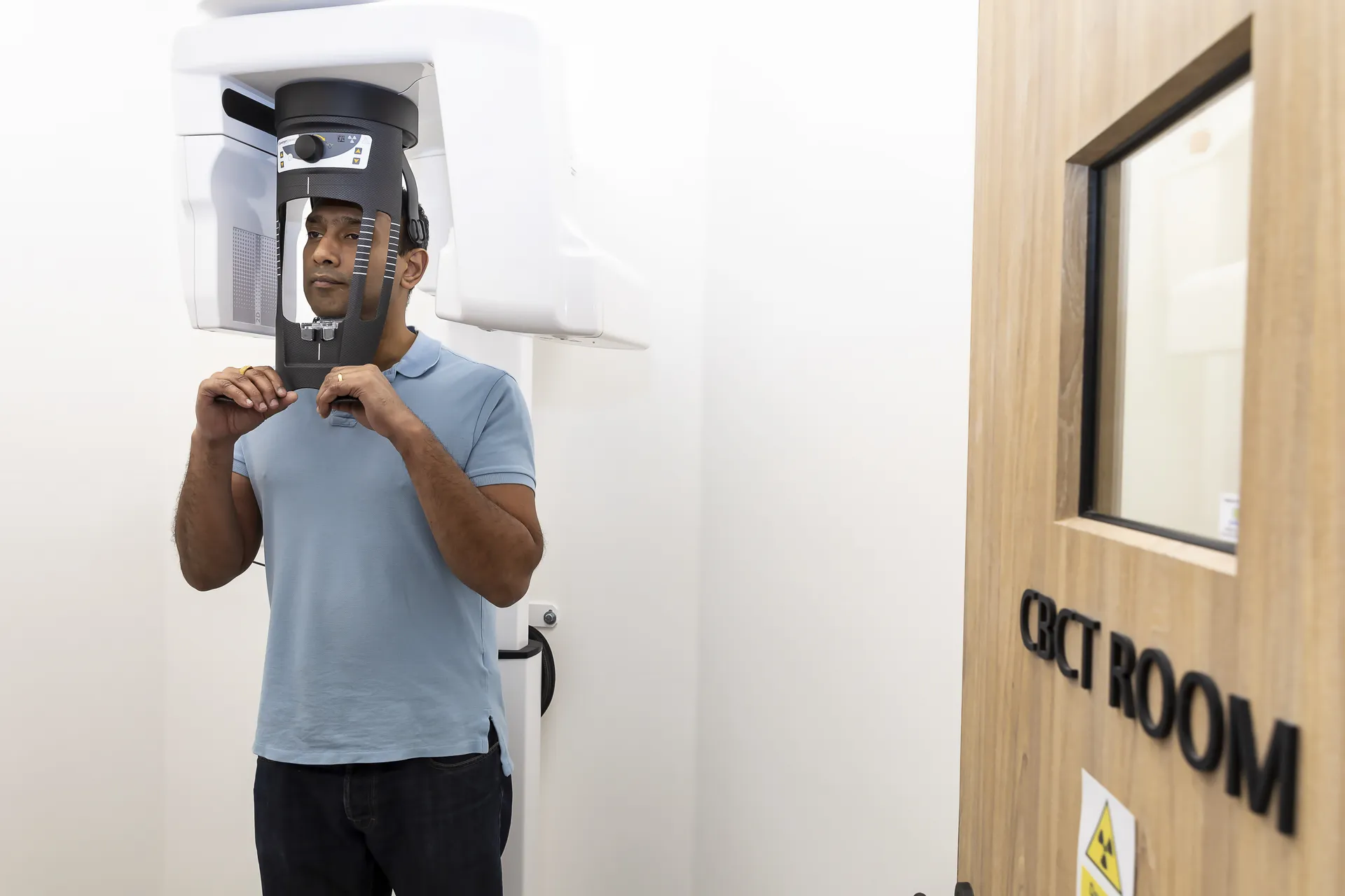 Patient positioned in the CBCT scanner at Bella Dental